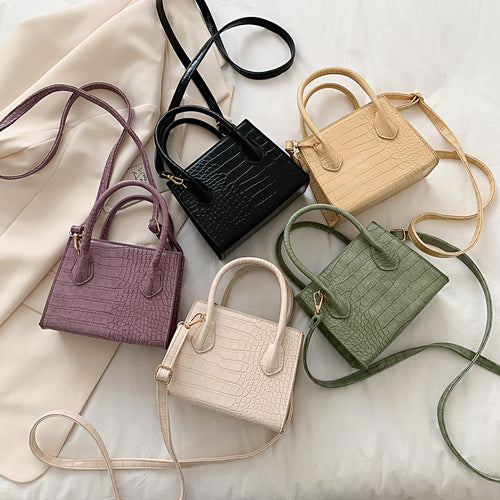 The solid color pattern and crocodile element give this bag a refined, versatile look that pairs with almost any outfit.