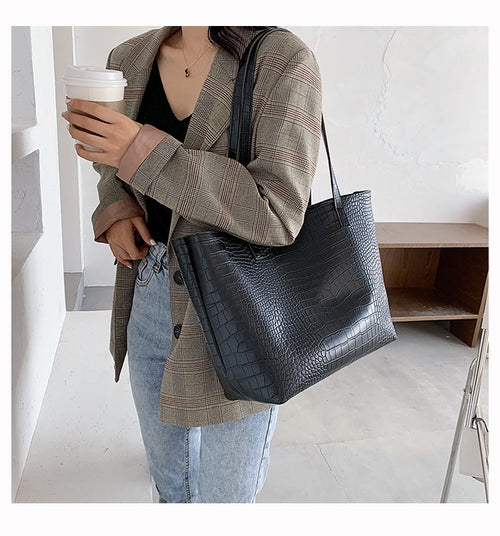 With defined upper width, lower width, and height measurements, this tote maintains a structured, put-together silhouette.