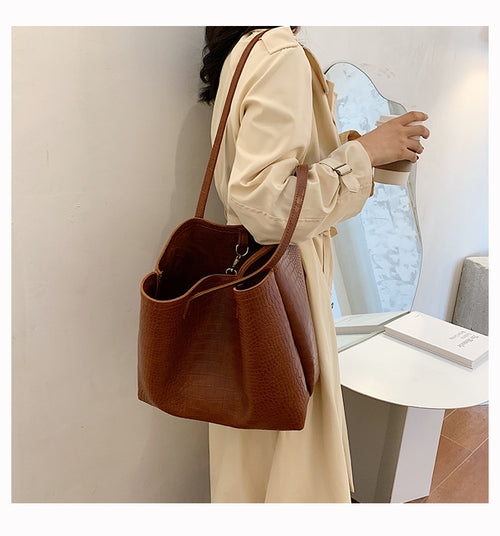 With defined upper width, lower width, and height measurements, this tote maintains a structured, put-together silhouette.