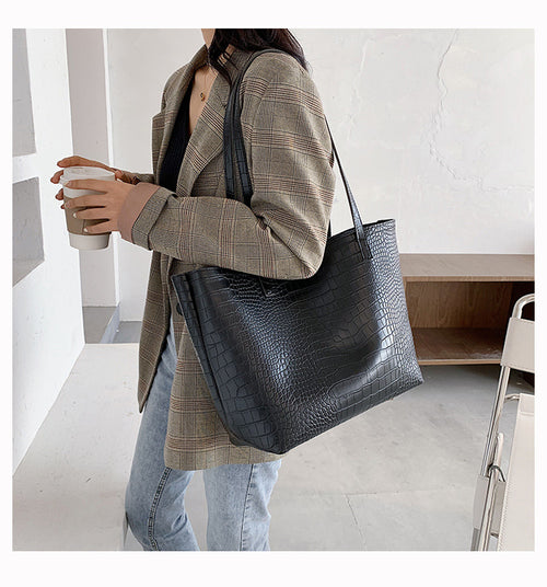 With defined upper width, lower width, and height measurements, this tote maintains a structured, put-together silhouette.