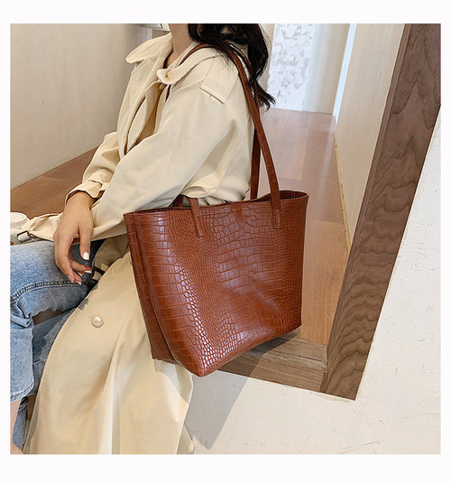 With defined upper width, lower width, and height measurements, this tote maintains a structured, put-together silhouette.
