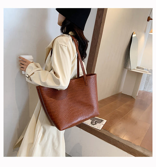 With defined upper width, lower width, and height measurements, this tote maintains a structured, put-together silhouette.