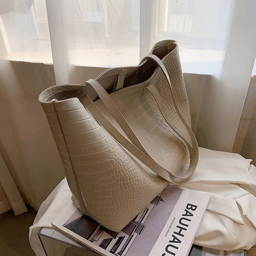 With defined upper width, lower width, and height measurements, this tote maintains a structured, put-together silhouette.