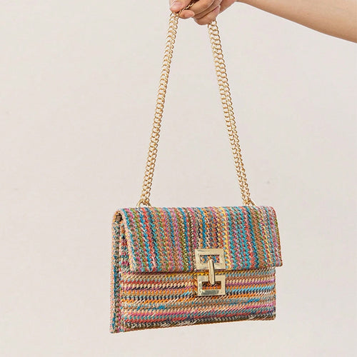The woven straw design with chain and lock details brings an instant vacation aesthetic to your everyday look.