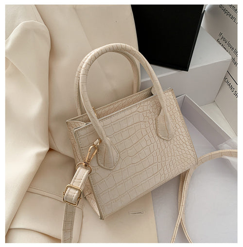The solid color pattern and crocodile element give this bag a refined, versatile look that pairs with almost any outfit.