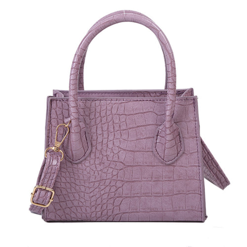 The solid color pattern and crocodile element give this bag a refined, versatile look that pairs with almost any outfit.