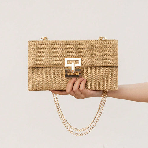 The woven straw design with chain and lock details brings an instant vacation aesthetic to your everyday look.